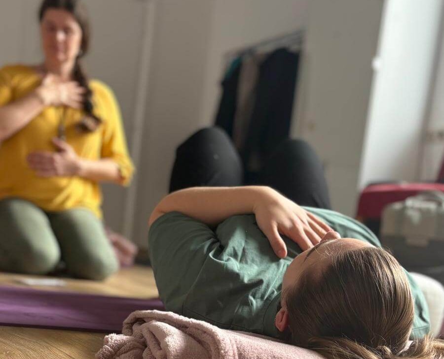 Breathwork - Atemtechniken. 2 Frauen atmen mit Hand auf Brust und Bauch.